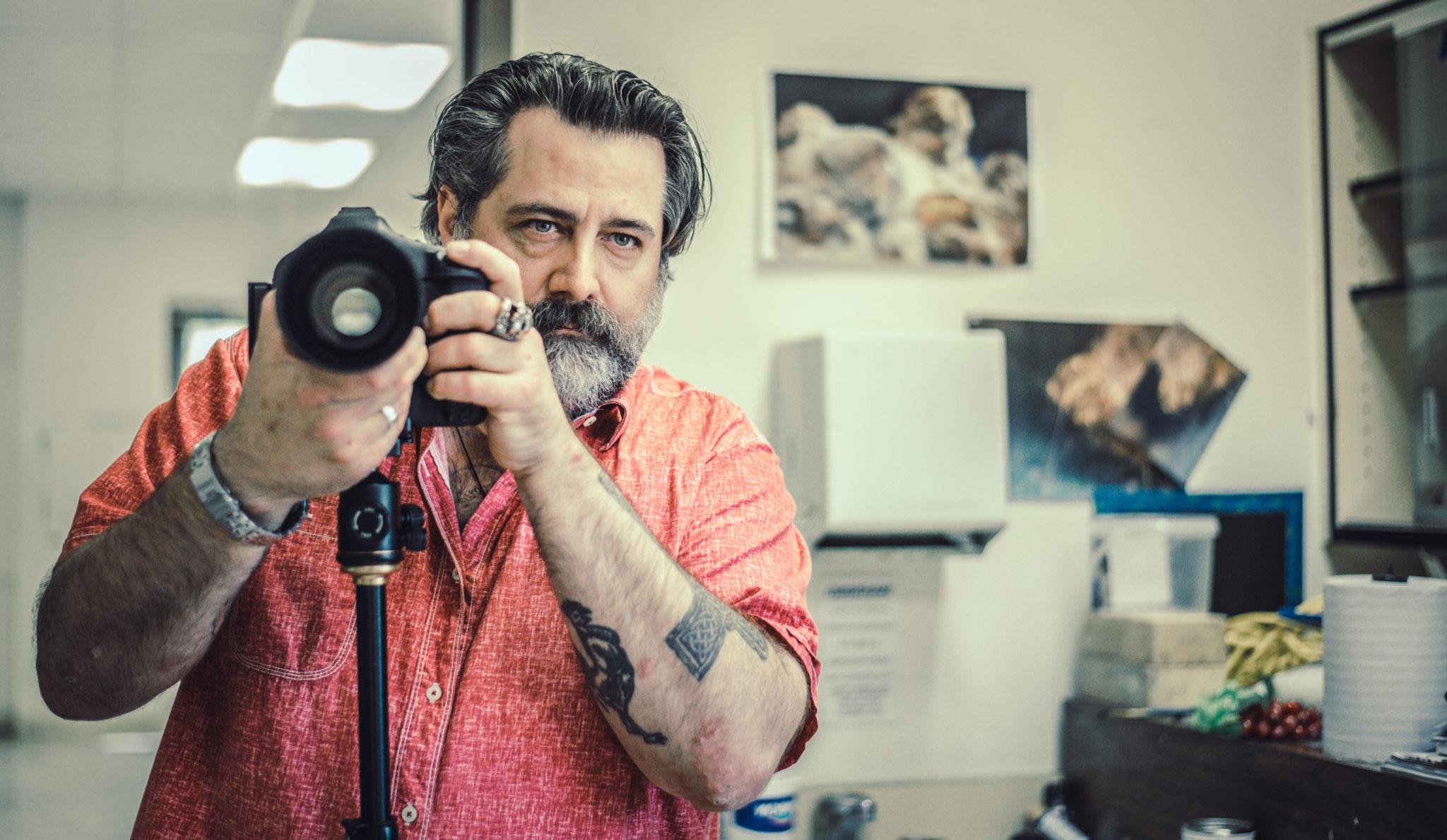 Student holding camera in a studio